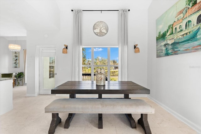 dining space featuring a notable chandelier