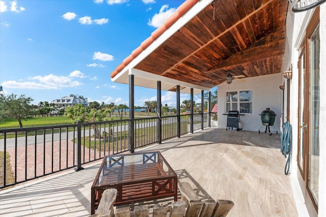 view of patio / terrace with a balcony, ceiling fan, and a grill