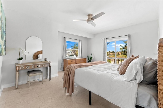 bedroom with multiple windows, ceiling fan, and access to exterior