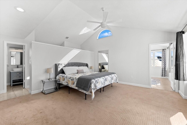 carpeted bedroom with ceiling fan, sink, and vaulted ceiling