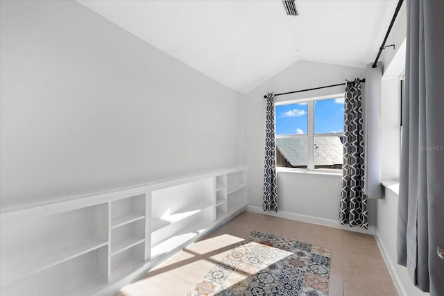 interior space featuring tile patterned floors and vaulted ceiling