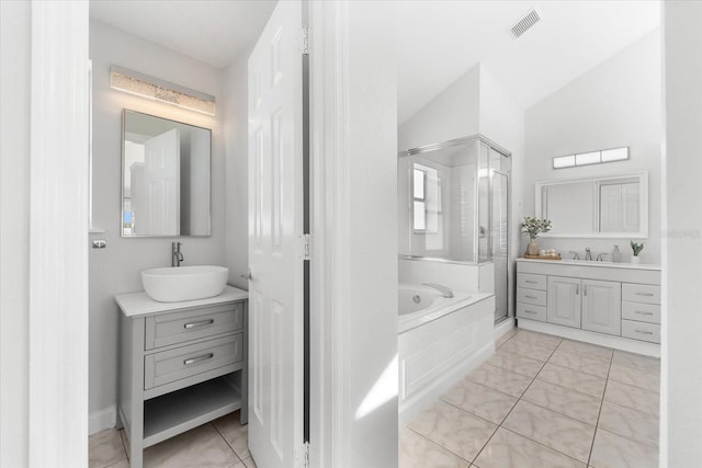 bathroom featuring plus walk in shower, tile patterned flooring, vanity, and vaulted ceiling