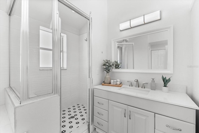 bathroom featuring vanity and tiled shower