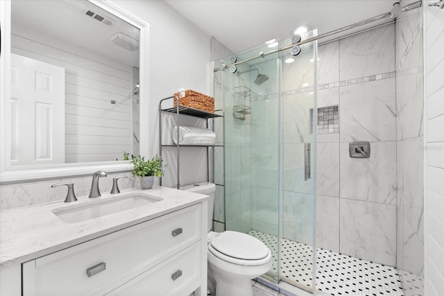 bathroom featuring vanity, toilet, and walk in shower