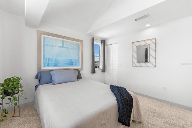 carpeted bedroom with lofted ceiling