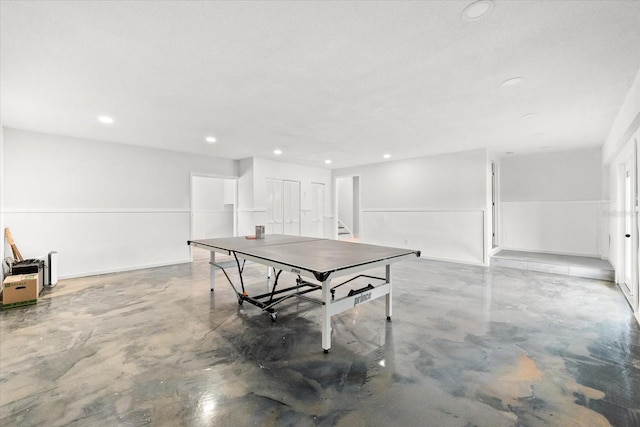 recreation room featuring concrete floors