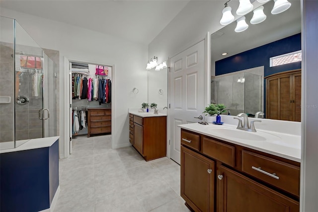 bathroom with tile patterned floors, vanity, and a shower with door