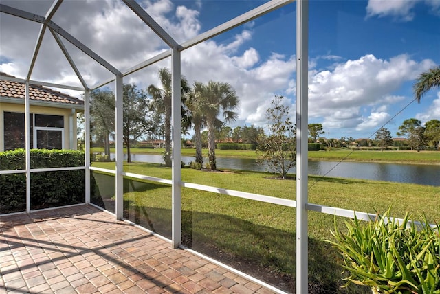 unfurnished sunroom featuring a water view