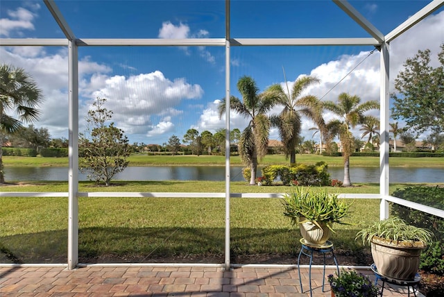 unfurnished sunroom featuring a water view