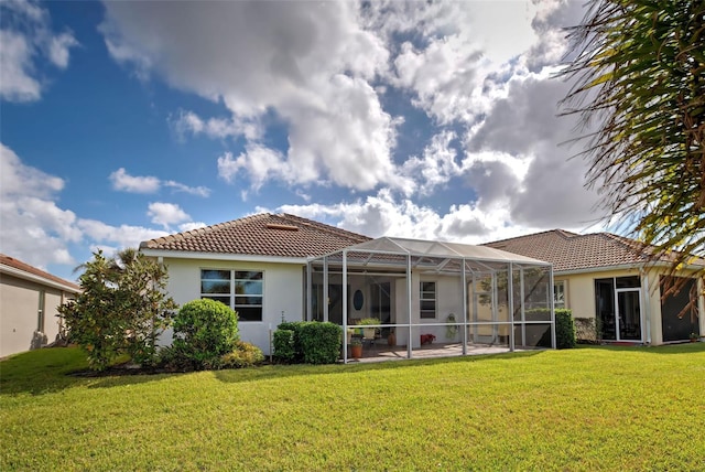 rear view of property featuring a lanai and a yard