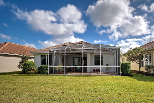 rear view of property with a patio area, a lanai, and a yard