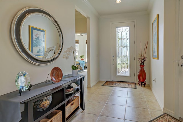 entrance foyer featuring plenty of natural light, light tile patterned floors, and crown molding