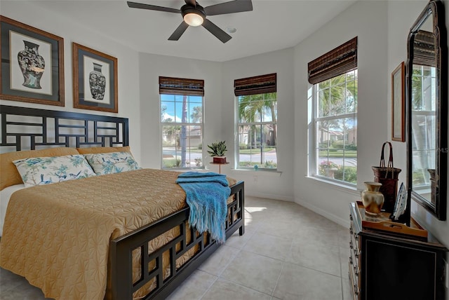 bedroom with ceiling fan and light tile patterned flooring