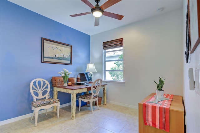 tiled home office featuring ceiling fan