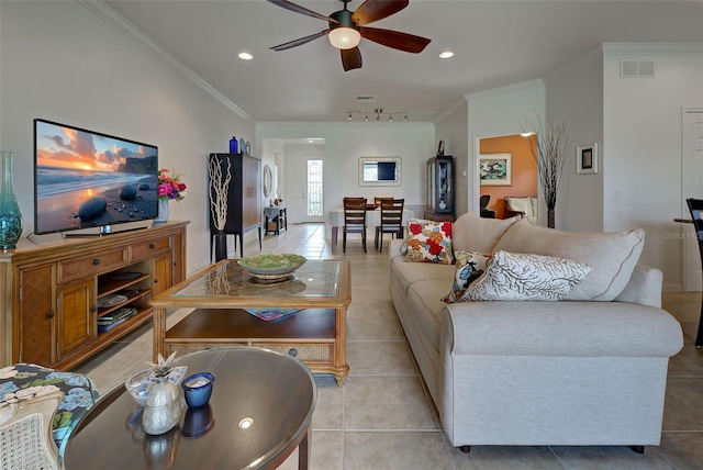 tiled living room featuring crown molding, ceiling fan, and track lighting