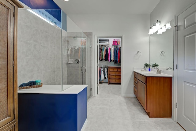 bathroom featuring tile patterned floors, vanity, and a shower with shower door