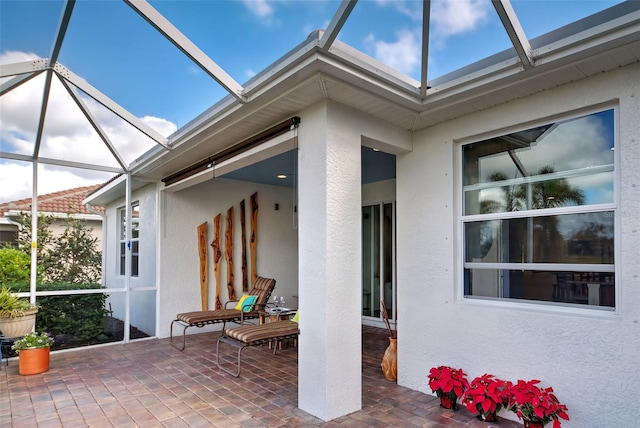 view of patio with glass enclosure