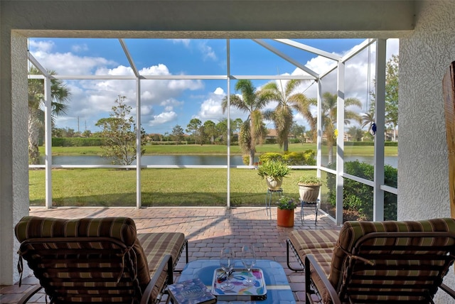 sunroom / solarium with a healthy amount of sunlight and a water view