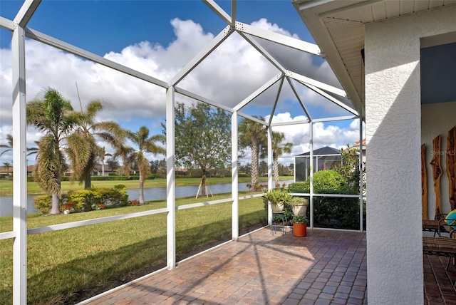 unfurnished sunroom with a swimming pool and a water view