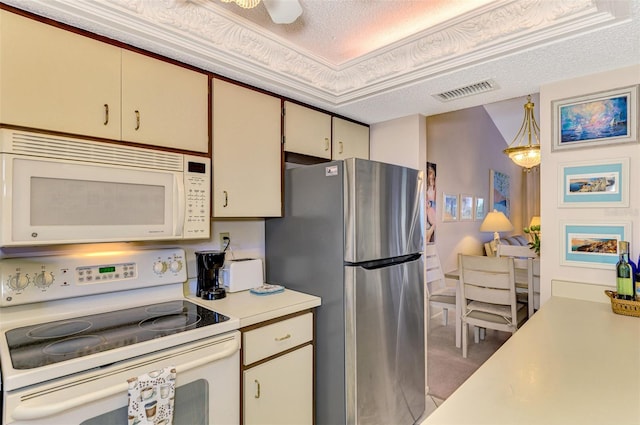 kitchen with pendant lighting, white appliances, cream cabinets, crown molding, and a textured ceiling