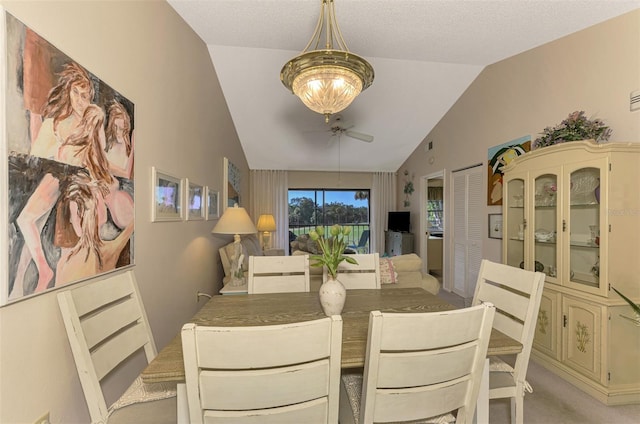 carpeted dining area with a textured ceiling, ceiling fan, and lofted ceiling