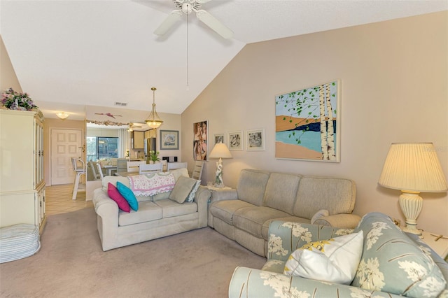 living room with ceiling fan, light carpet, and lofted ceiling