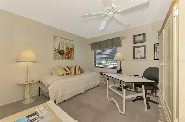 carpeted bedroom with a textured ceiling and ceiling fan