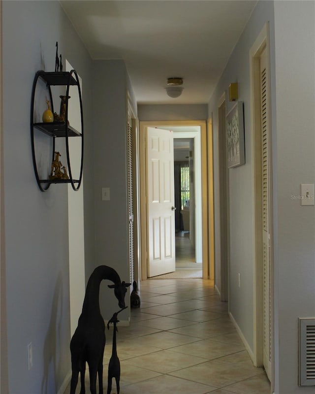 hallway featuring light tile patterned floors