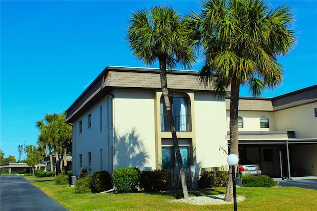 view of side of home featuring a lawn