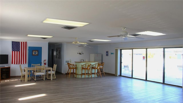 interior space featuring crown molding, ceiling fan, and hardwood / wood-style flooring