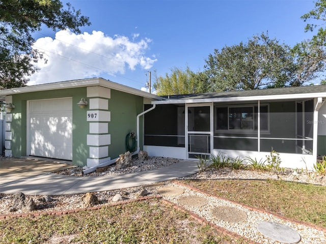 view of front of house with a garage and a sunroom