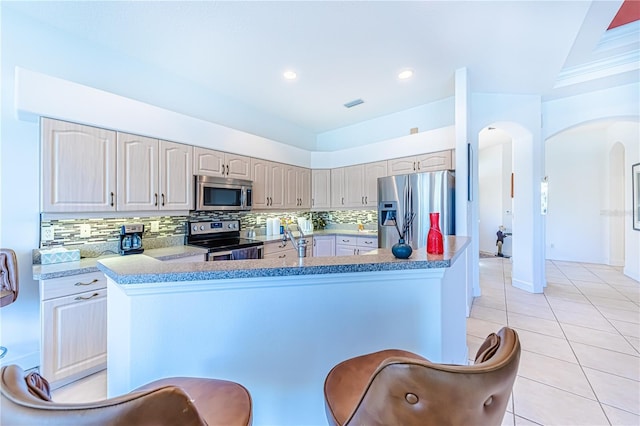 kitchen with light tile patterned floors, sink, backsplash, stainless steel appliances, and ornamental molding