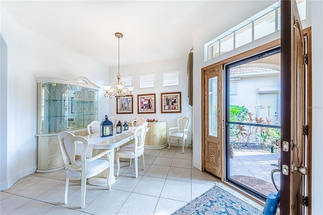 tiled dining area featuring an inviting chandelier