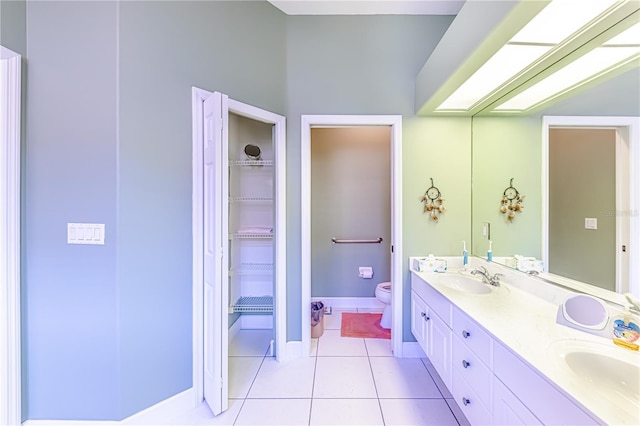 bathroom featuring vanity, tile patterned floors, and toilet