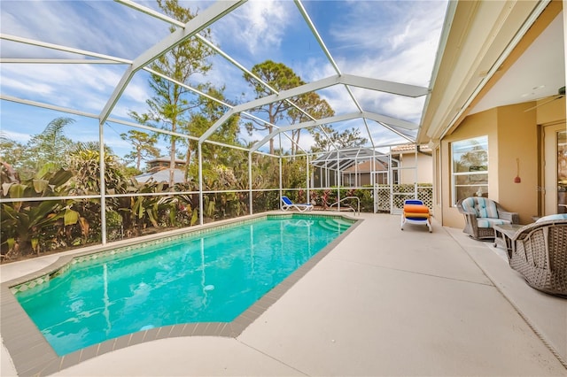 view of pool featuring a patio area and glass enclosure