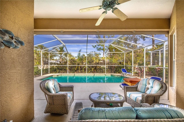 exterior space with ceiling fan, a patio, and glass enclosure