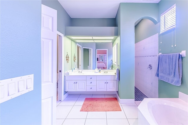 bathroom with vanity, tile patterned floors, and plus walk in shower