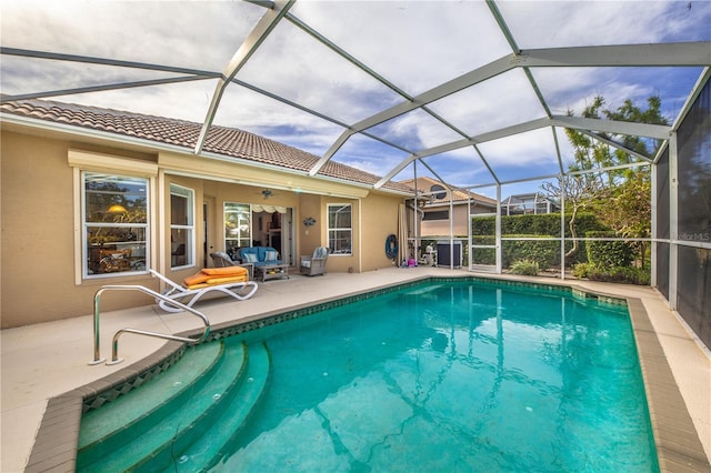 view of pool with a lanai and a patio