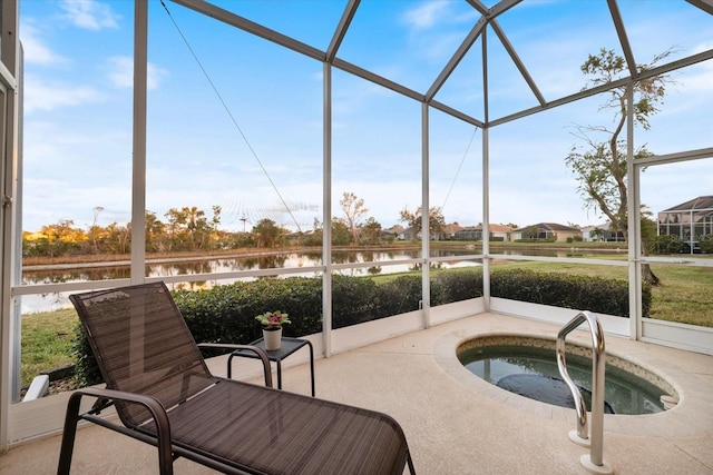 sunroom featuring a jacuzzi and a water view