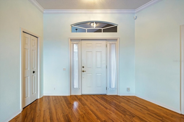 foyer entrance with hardwood / wood-style floors and ornamental molding