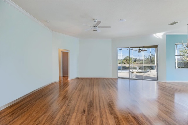 unfurnished room with a notable chandelier, light wood-type flooring, and crown molding