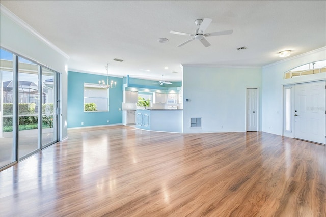 unfurnished living room featuring ceiling fan with notable chandelier, light wood-type flooring, and crown molding