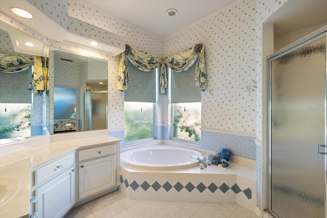 bathroom featuring vanity, tile patterned flooring, and separate shower and tub