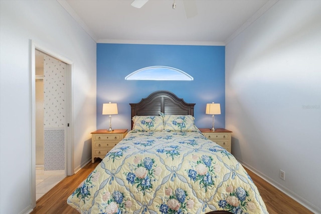 bedroom featuring ornamental molding, light wood-type flooring, and ceiling fan