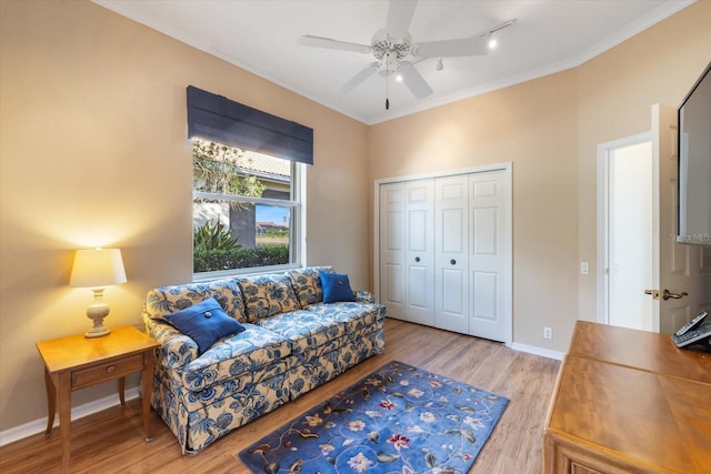 living room featuring ceiling fan, ornamental molding, and hardwood / wood-style flooring