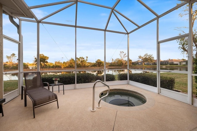 sunroom featuring a water view