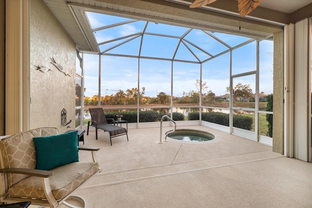 view of pool featuring a jacuzzi and a water view