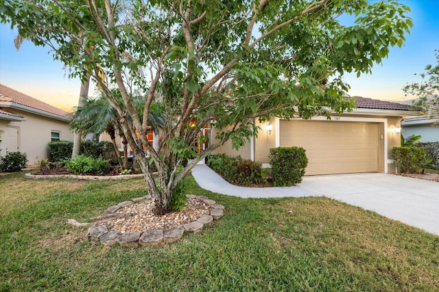 view of front of home with a yard and a garage