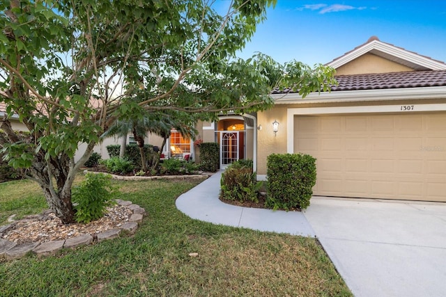 view of front of property with a garage and a front lawn