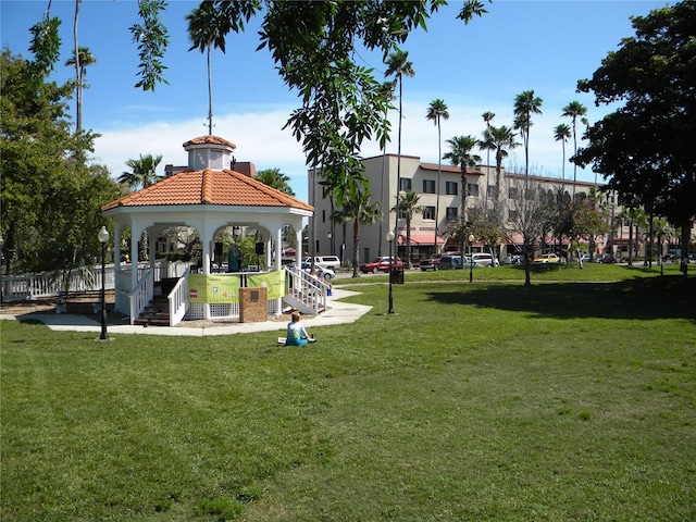 surrounding community with a lawn and a gazebo